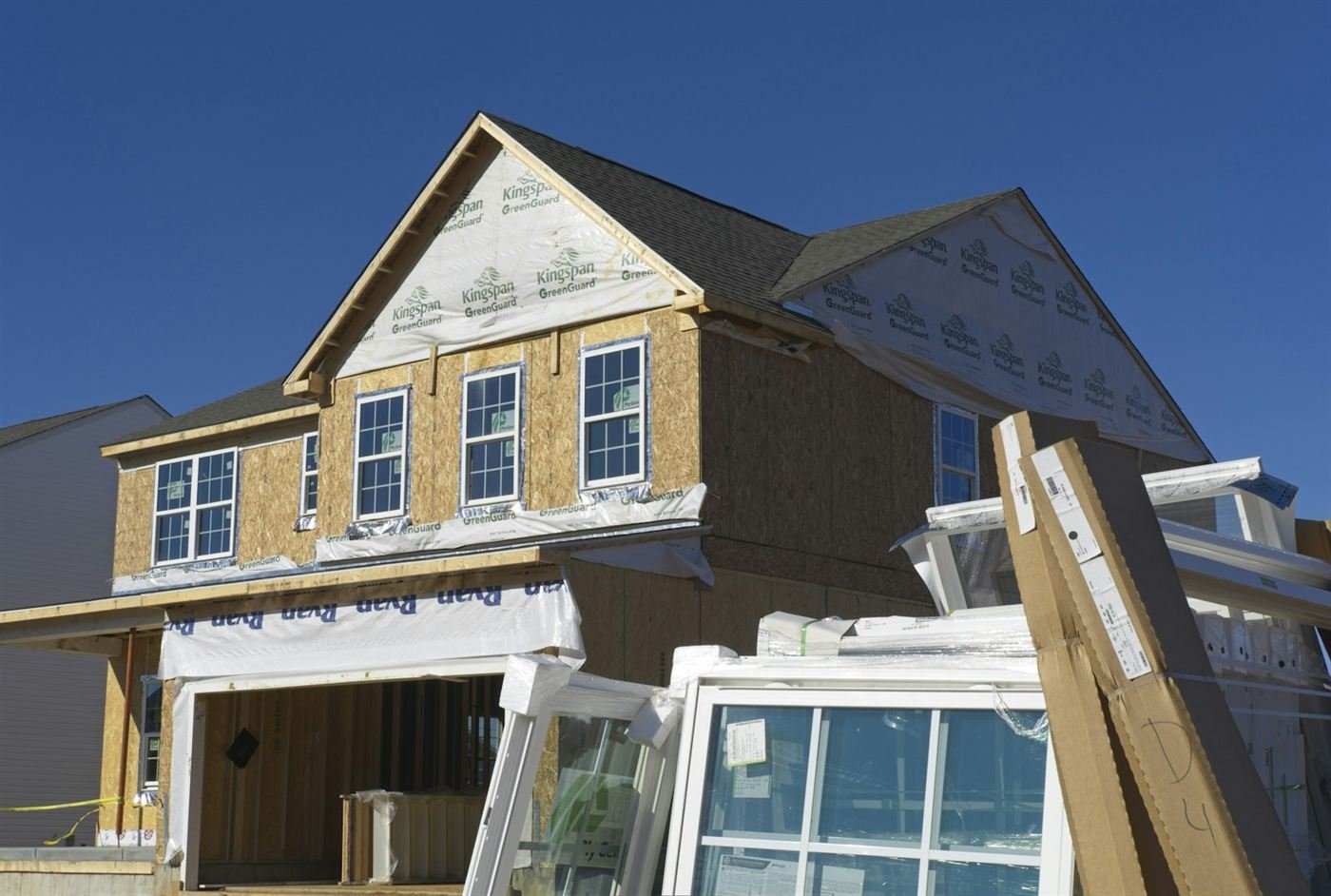 New windows stacked at a home under construction