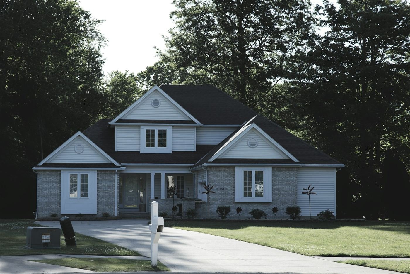 Suburban home with white siding and a green lawn